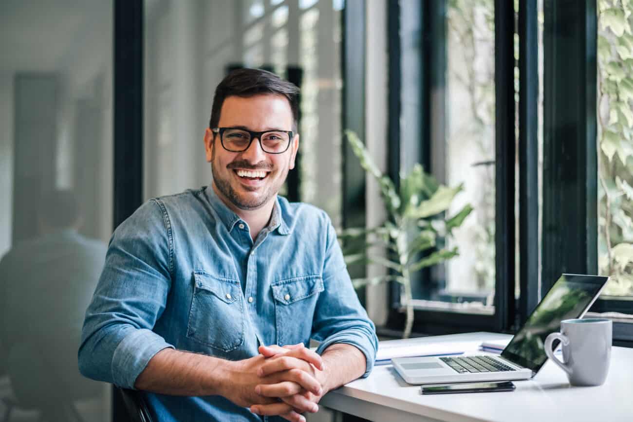 Happy sales professional who is enjoying success smiling at the camera.