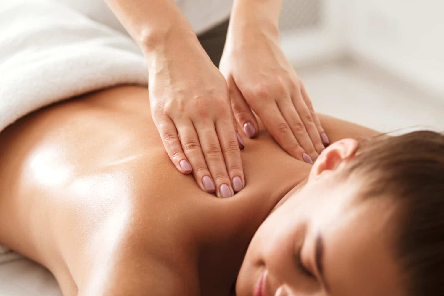 A image of a women receiving a calming massage used to invoke emotion in marketing communications.